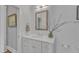 Close up on a bright bathroom featuring a white vanity, framed mirror, and decorative decor at 425 Morrison Ave, Raleigh, NC 27608