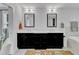 Bright bathroom features a double vanity with black cabinets and neutral tile flooring at 425 Morrison Ave, Raleigh, NC 27608