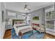 Comfortable bedroom with a ceiling fan, windows with exterior views and an area rug at 425 Morrison Ave, Raleigh, NC 27608