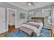 Comfortable bedroom with a rug, ceiling fan, bedside tables and a view to the bathroom at 425 Morrison Ave, Raleigh, NC 27608