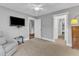 Bedroom with a ceiling fan, neutral walls and carpet, and a view into the hallway at 425 Morrison Ave, Raleigh, NC 27608