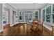 Bright dining room with hardwood floors and a round table with seating for four at 425 Morrison Ave, Raleigh, NC 27608
