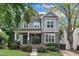 A picturesque two-story home with a covered front porch and beautifully landscaped front yard at 425 Morrison Ave, Raleigh, NC 27608