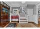 Elegant foyer featuring hardwood floors, a staircase, and a striking wooden front door at 425 Morrison Ave, Raleigh, NC 27608