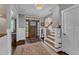 A bright foyer showcases hardwood floors, a staircase, and a striking wood front door at 425 Morrison Ave, Raleigh, NC 27608