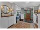 Inviting foyer with elegant rugs, built-in cabinetry, and a view into adjacent living spaces at 425 Morrison Ave, Raleigh, NC 27608