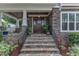 Close up of front entrance with beautiful stone steps and an elegant dark wood door at 425 Morrison Ave, Raleigh, NC 27608