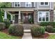 Inviting front porch featuring stone accents, a dark wood door, and well-maintained landscaping at 425 Morrison Ave, Raleigh, NC 27608
