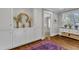 Upstairs hallway featuring an oriental rug, storage cabinets, and a view to a bedroom at 425 Morrison Ave, Raleigh, NC 27608