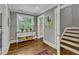 Hallway with hardwood floors, a window, a decorative table, and entry to the stairwell at 425 Morrison Ave, Raleigh, NC 27608