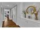 Elegant hallway featuring hardwood floors, white cabinets, and decorative gold mirror at 425 Morrison Ave, Raleigh, NC 27608