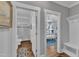 Hallway view into a bathroom with a glass shower and a bedroom featuring a ceiling fan and bright windows at 425 Morrison Ave, Raleigh, NC 27608