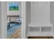 Hallway showcasing a built-in bench with storage and coat hooks with a view into a sitting room at 425 Morrison Ave, Raleigh, NC 27608