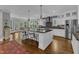 Bright kitchen featuring a large island with bar seating, hardwood floors, and stainless steel appliances at 425 Morrison Ave, Raleigh, NC 27608
