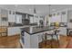 Stylish kitchen with a spacious island, stainless steel appliances, hardwood floors, and ample cabinet space at 425 Morrison Ave, Raleigh, NC 27608