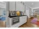 Gourmet kitchen with built in oven and microwave, sleek countertops, and custom cabinetry at 425 Morrison Ave, Raleigh, NC 27608