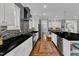 Well-lit kitchen with stone backsplash, stainless steel range and dark counter tops at 425 Morrison Ave, Raleigh, NC 27608