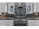 Close-up of the kitchen range featuring stone backsplash and stainless steel accents at 425 Morrison Ave, Raleigh, NC 27608