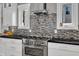 Close up view of a stainless steel oven and mosaic backsplash in an updated kitchen at 425 Morrison Ave, Raleigh, NC 27608