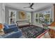 Bright living area with hardwood floors, large windows, a ceiling fan, and comfortable seating at 425 Morrison Ave, Raleigh, NC 27608