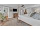 Bright main bedroom with a four-poster bed, flat screen tv, and a glimpse into the bathroom at 425 Morrison Ave, Raleigh, NC 27608