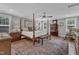 Spacious main bedroom with a four-poster bed, patterned rug, and ample natural light at 425 Morrison Ave, Raleigh, NC 27608