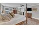 Comfortable main bedroom featuring a four-poster bed, hardwood floors, and flat screen tv at 425 Morrison Ave, Raleigh, NC 27608