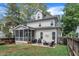 Exterior of home featuring a screened-in porch and stone patio with seating and a grill at 425 Morrison Ave, Raleigh, NC 27608
