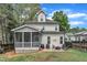 Exterior of home featuring a screened-in porch and stone patio with seating and a grill at 425 Morrison Ave, Raleigh, NC 27608