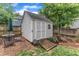Backyard shed featuring a wooden ramp and bordered by a wooden fence and mulch at 425 Morrison Ave, Raleigh, NC 27608