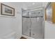 A bathroom featuring a tiled glass shower with black trim, a framed art, and a toilet at 425 Morrison Ave, Raleigh, NC 27608