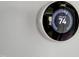 Nest thermostat on a wall with a digital display showing the set temperature at 425 Morrison Ave, Raleigh, NC 27608