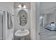 Modern powder room with a sleek pedestal sink and stylish fixtures, conveniently located near the living area at 445 Brier Summit Pl, Durham, NC 27703