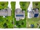 Aerial view of a home with a well-maintained lawn, solar panels, and a backyard deck with a fire pit at 45 Imperial Dr, Clayton, NC 27527