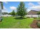 Lush backyard with mature trees, well-manicured lawn, playset, and garden beds, ideal for outdoor living at 45 Imperial Dr, Clayton, NC 27527