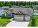 Well-manicured lawn with a three car garage in a two-story home with blue siding and a gray roof at 45 Imperial Dr, Clayton, NC 27527