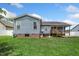 Back of a house with blue siding, screened in back porch, hot tub, and a manicured backyard at 45 Imperial Dr, Clayton, NC 27527