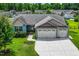 Charming blue home with a manicured lawn, three-car garage, and inviting front porch at 45 Imperial Dr, Clayton, NC 27527