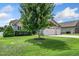 A home with a well-manicured front lawn featuring an ornamental tree and three-car garage at 45 Imperial Dr, Clayton, NC 27527