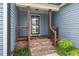 Close-up of the front porch with brick steps and wooden railings at 45 Imperial Dr, Clayton, NC 27527