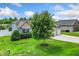 A well-maintained front yard with green grass and a large tree in front of a blue home at 45 Imperial Dr, Clayton, NC 27527