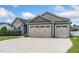 Spacious three-car garage with a concrete driveway and an attached blue-gray home at 45 Imperial Dr, Clayton, NC 27527