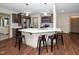 Open-concept kitchen boasts stainless appliances, a mosaic backsplash, and breakfast bar with pendant lighting at 45 Imperial Dr, Clayton, NC 27527