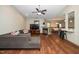 Spacious living room with hardwood floors, fireplace, ceiling fan, and open view to the dining area and kitchen at 45 Imperial Dr, Clayton, NC 27527