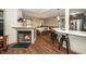 Open concept living room with hardwood floors, fireplace, kitchen with breakfast bar and dining area at 45 Imperial Dr, Clayton, NC 27527