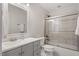 Modern bathroom with glass shower door, gray vanity, and a decorative mirror at 5003 Celtic Ct, Raleigh, NC 27612