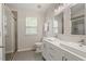 Bathroom featuring double sinks, white cabinets and drawers, and walk in shower with tile surround at 5003 Celtic Ct, Raleigh, NC 27612