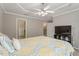 Bedroom featuring a tray ceiling, ceiling fan, and walk in closet at 5003 Celtic Ct, Raleigh, NC 27612