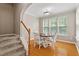 Charming dining area with views from ample windows, adjacent to a staircase at 5003 Celtic Ct, Raleigh, NC 27612