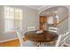 Cozy dining area with a dark wood table and bright windows to a charming view at 5003 Celtic Ct, Raleigh, NC 27612